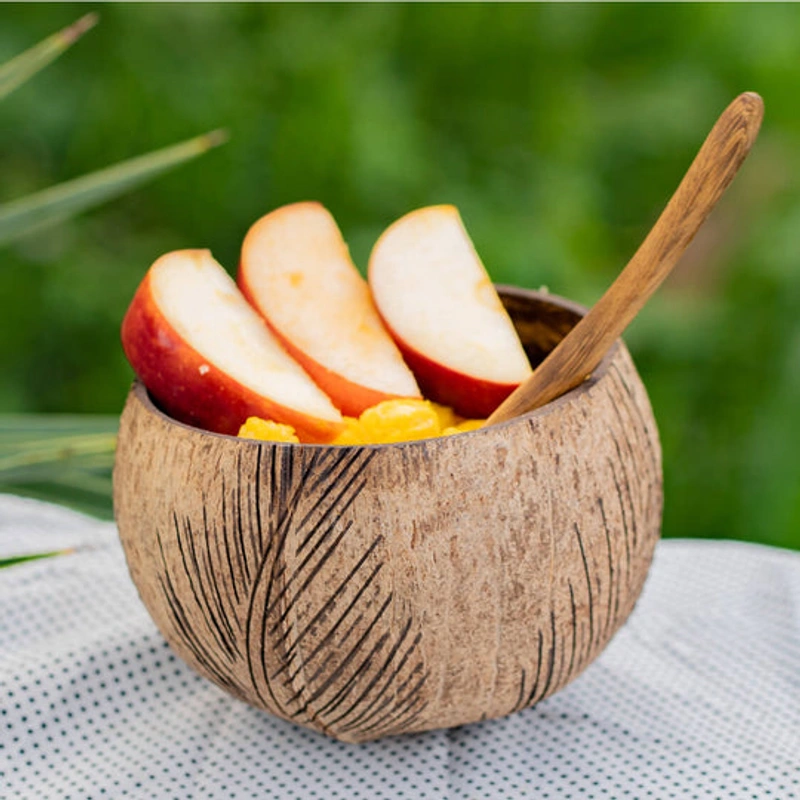 Similar leaf carved coconut bowl with fruit in a natural setting
