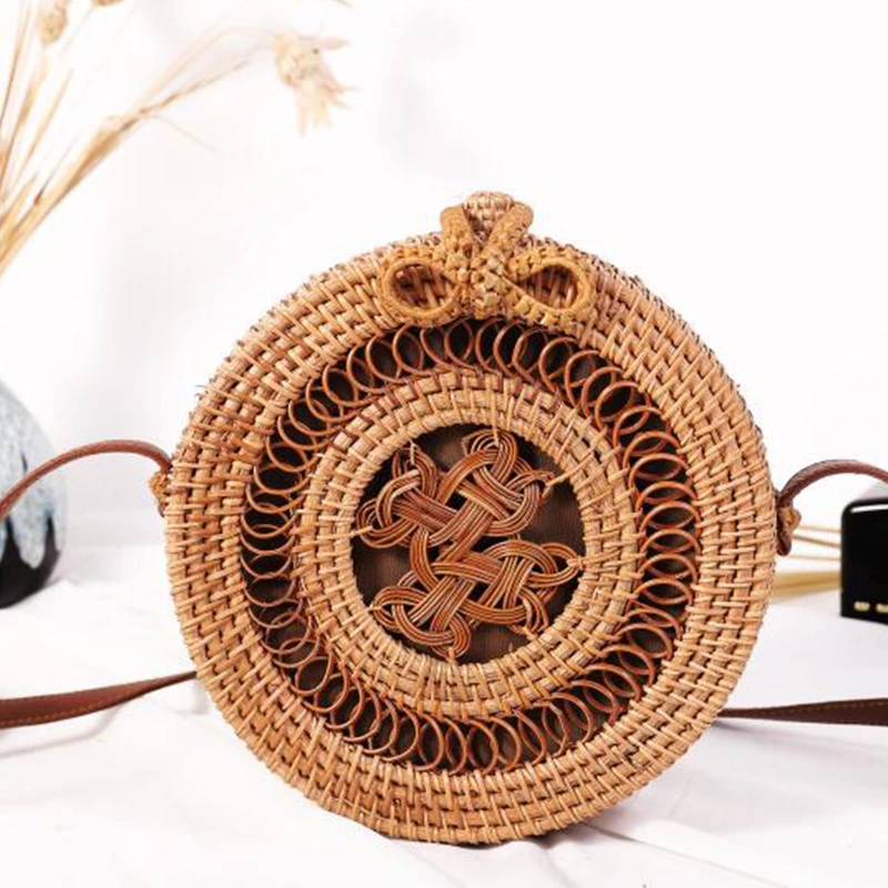 decorative round rattan bag with brown shoulder strap