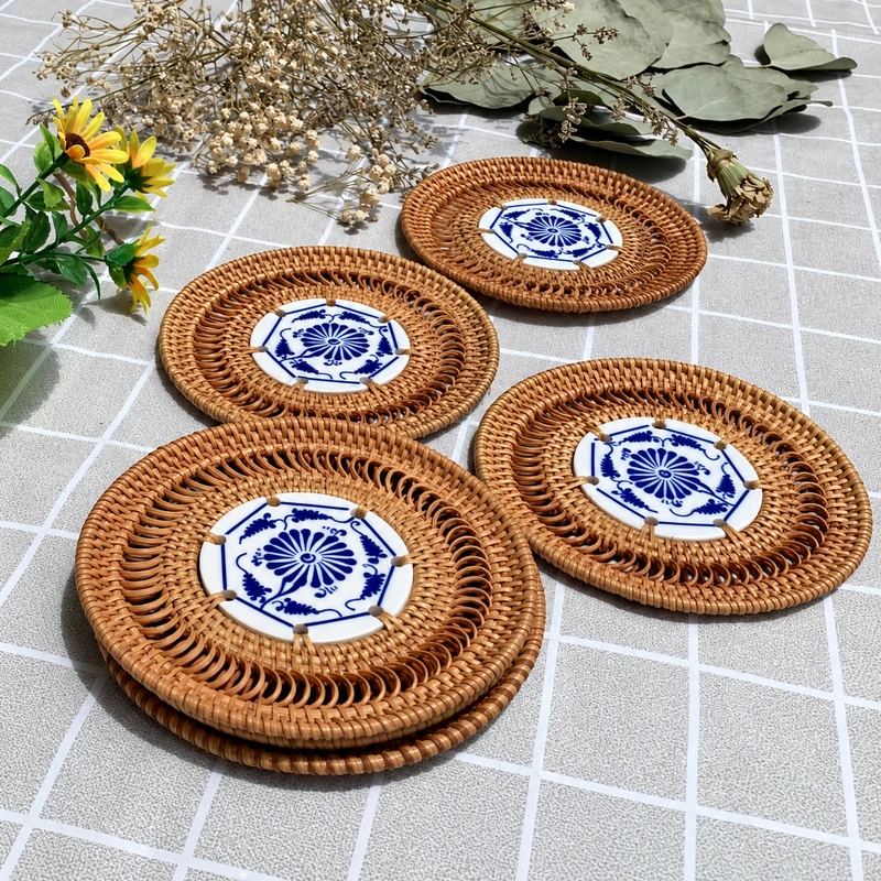 Assorted ceramic-centred rattan coasters on a tabletop Assorted ceramic-centred rattan coasters on a tabletop