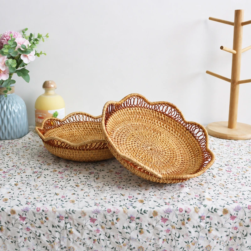Scalloped Rattan Tray | 2 Handwoven Sizes 7 Two scalloped trays displayed on a floral tablecloth