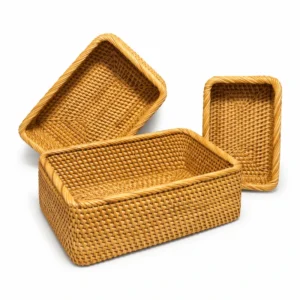 Three rectangular rattan storage baskets on white