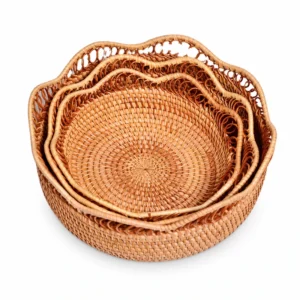 Three nested decorative rattan fruit baskets on white