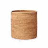 cylindrical rattan storage basket on a white background
