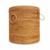 round lidded rattan hamper on a white background