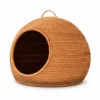 domed rattan cat bed on a white background